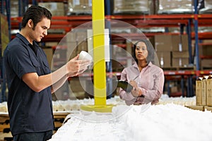 Factory Worker And Manager Checking Goods On Production Line