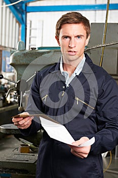 Factory Worker Reading Redundancy Letter