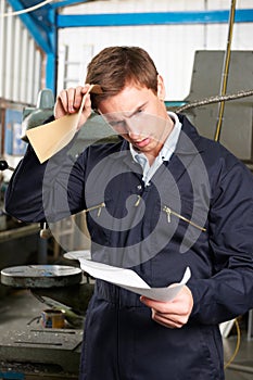 Factory Worker Reading Redundancy Letter