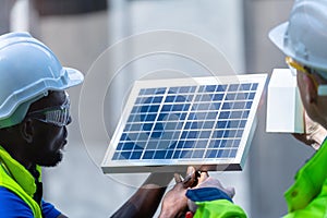 Factory worker technician engineer men showing and checking solar cell panel for sustainable technology with working suit and