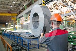 Factory worker transporting cargo with crane