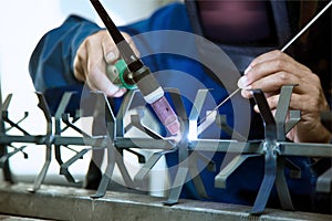 Factory worker welding metal