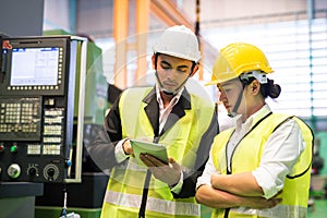 Factory workers check stock in tablet