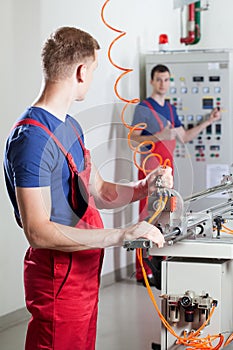 Factory workers during dangerous machine repair