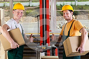Factory workers showing thumbs up sign