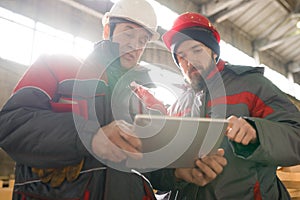 Factory Workers Using Tablet