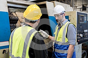 Factory workers working and discussing in factory. Engineer men wearing uniform safety in factory