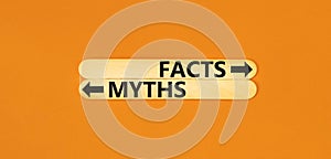 Facts or myths symbol. Concept word Myths and Facts on beautiful wooden stick. Beautiful orange table orange background. Business