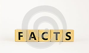 Facts symbol. The concept word `facts` on wooden cubes. Beautiful white table, white background, copy space. Business, fact and