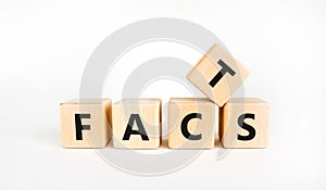 Facts symbol. The concept word `facts` on wooden cubes. Beautiful white table, white background, copy space. Business, fact and