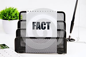 Facts, truth or accurate information in media news or business concept. FACT on a piece of paper on a white background photo