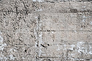 Facture of a concrete wall with white splits removed by a sunny day
