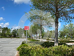 A faculty parking sign in a parking lot