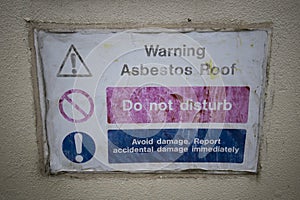 Faded Asbestos roof warning sign