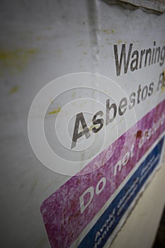 Faded Asbestos roof warning sign