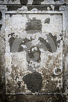 Faded cross on an old parget wall