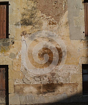 Faded and crumbling plaster wall for backgrounds