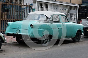 Faded Glory: Vintage North American Classic Car in Turquoise and White, Weathered but Timeless