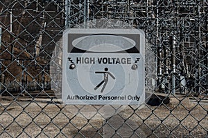 Faded High Voltage Danger Sign on Chainlink