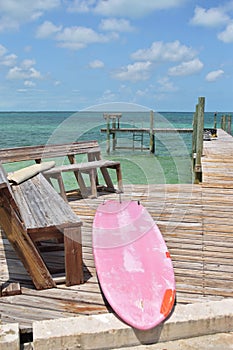 Faded paddle board on dock