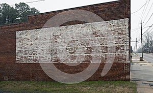 Faded painted sign on rustic old brick wall texture store or building