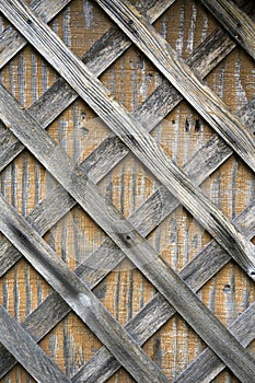 Faded from rains and sun wooden slats nailed to wooden plywood photo