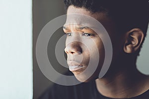 Faded retro portrait of a worried African boy photo