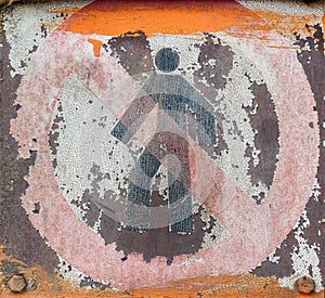 Faded and shabby sign of danger on a metal plate