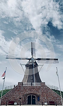 Faded Windmill with Wispy Clouds and Blue Sky in Fulton, Illinois photo