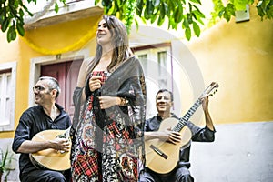 Fado band performing traditional portuguese music in the courtyard in Lisbon, Portugal photo