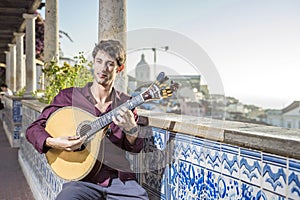 Fado musician playing on portuguese guitar in Lisbon, Portugal