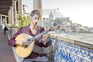 Fado musician playing on portuguese guitar in Lisbon, Portugal