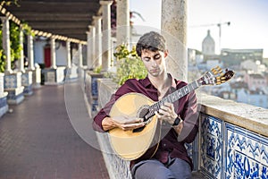 Fado musician playing on portuguese guitar in Lisbon, Portugal