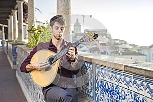 Fado musician playing on portuguese guitar in Lisbon, Portugal