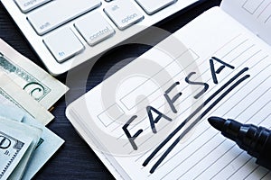 FAFSA handwritten in a note. Free Application for Federal Student Aid. photo