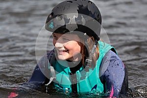 Wakeboarding. Girl wakeboarder falls into the water after an unsuccessful jump