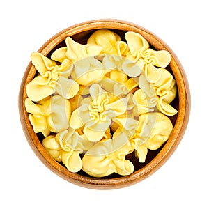 Fagottini, filled Italian pasta, raw dumplings in a wooden bowl