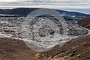 Fagradalsfjall volcano lava field with frozen basaltic lava created after eruption and steaming vents, Iceland