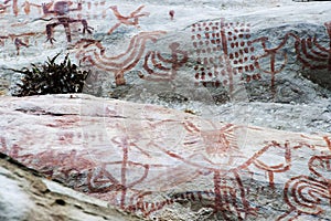 cave paintings in San Ignacio Cajamarca Peru with hunters and warriors using boleadora stones dating from 5,000 to 10,000 photo