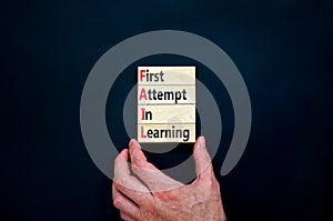 FAIL first attempt in learning symbol. Wooden blocks with words FAIL first attempt in learning. Beautiful black table, black