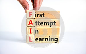 FAIL first attempt in learning symbol. Wooden blocks with words FAIL first attempt in learning. Beautiful white table, white