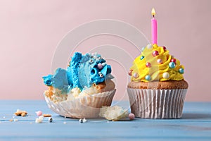 Failed and good cupcakes on blue wooden table. Troubles happen