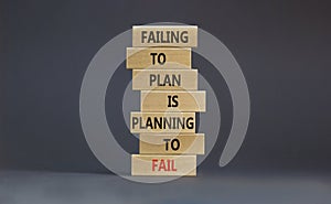 Failing to plan or planning fail symbol. Wooden blocks with words Failing to plan is planning to fail. Beautiful grey background, photo