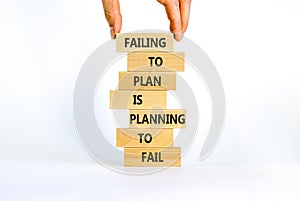 Failing to plan or planning fail symbol. Wooden blocks with words Failing to plan is planning to fail. White background, copy