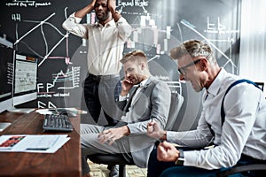 Failure. Cropped shot of trader coach disappointed with work of team. Three colleagues looking angrily at the computer