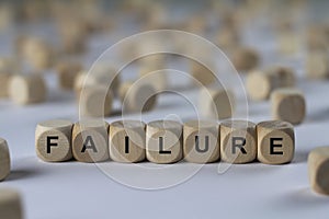 Failure - cube with letters, sign with wooden cubes