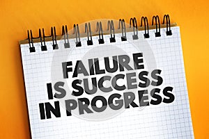 Failure Is Success In Progress text quote on notepad, concept background