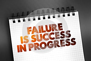 Failure Is Success In Progress text quote on notepad, concept background