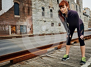 Failure will never overtake you if your determination is unfaltering. a sporty young woman taking a break while running