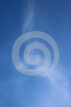 Faint wispy white clouds abstract pattern blue sky